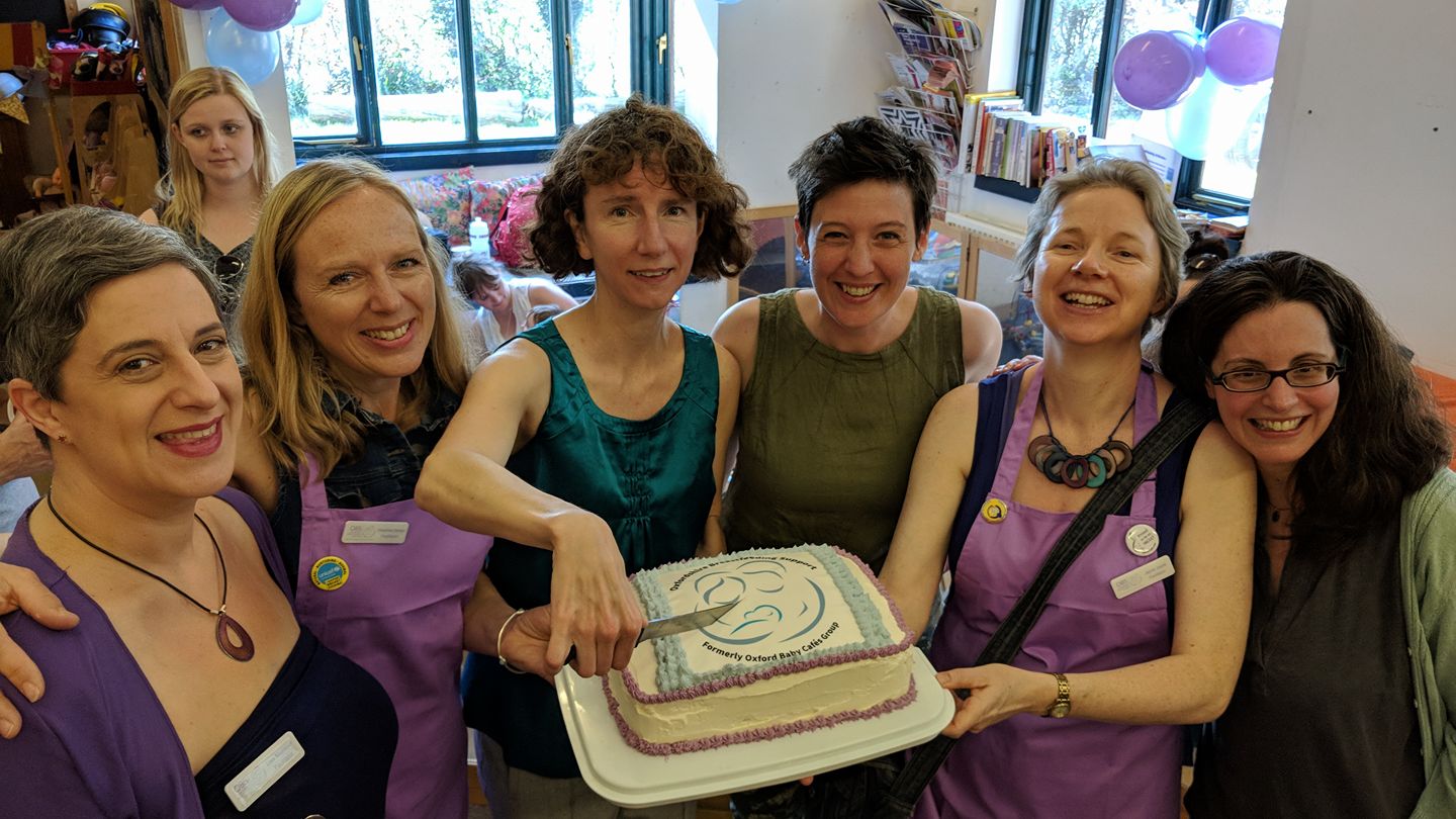 Facilitators and supporters with cake